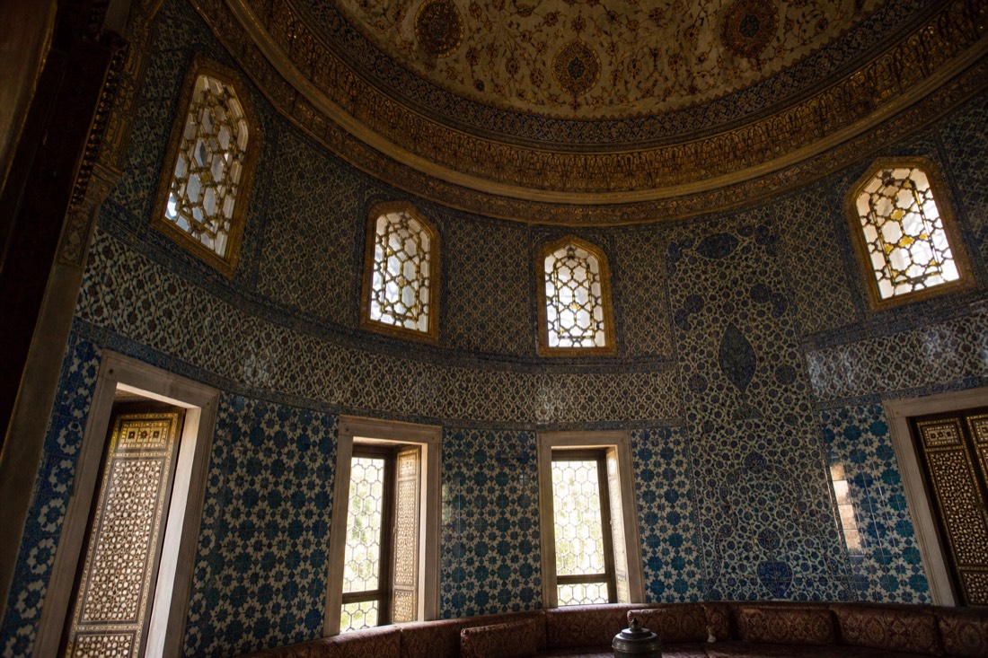 The richly tiled interior of the Baghdad Kiosk pavilion at Topkapi with a patterned dome above