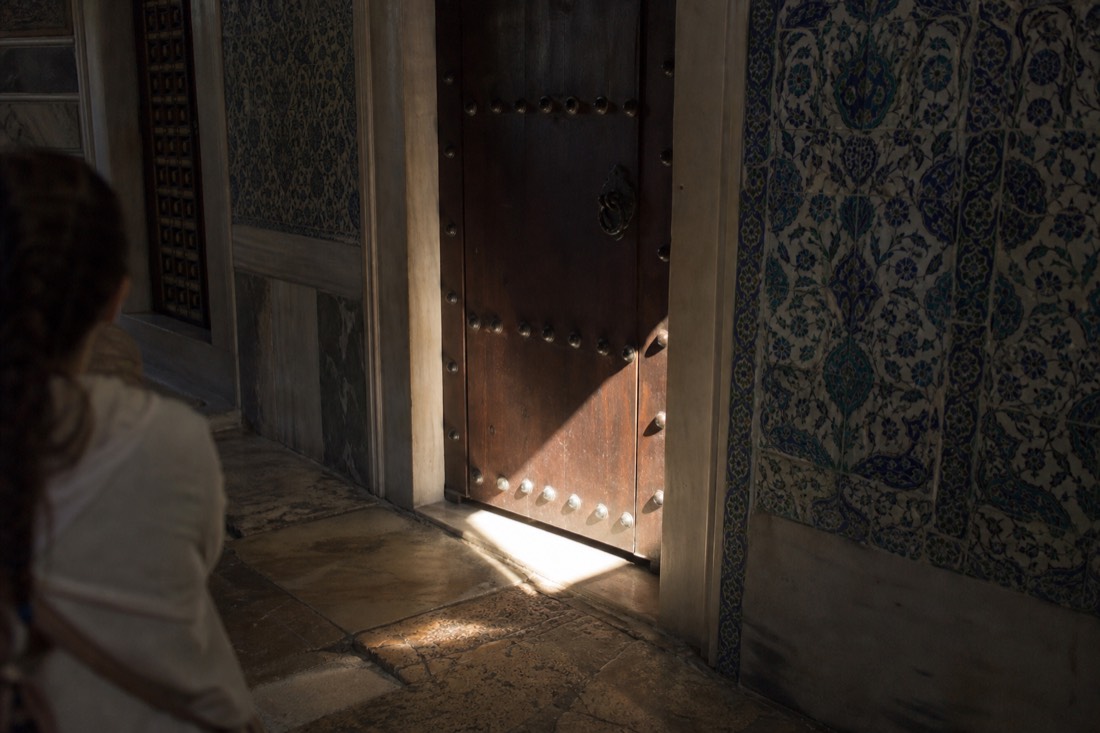 Heavy wooden door with iron fittings in a tiled passage of the Topkapi Palace Harem
