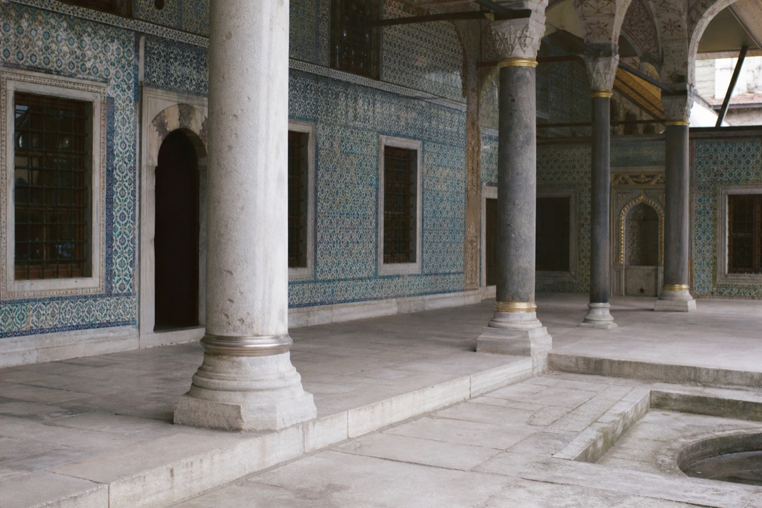A tiled colonnaded courtyard inside the Topkapı Palace Harem in soft daylight