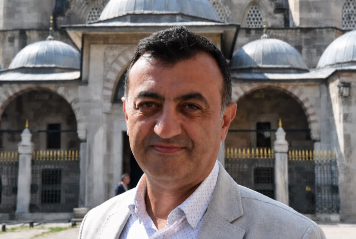 Mehmet Demir, Istanbul Topkapi Palace ticket specialist and cultural guide, outside an Ottoman monument in Istanbul